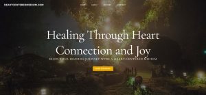 Heart to Heart: Website for a Medium and Spiritual Guide featured image of the website hero image. A tree covered in lights and shrouded by fog.